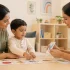 Parent and child working with a developmental specialist on a milestone activity at a child development center in Kerala