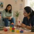 Therapist conducting ADHD assessment with young child using visual aid cards at AIMS Child Development Centre Pattambi
